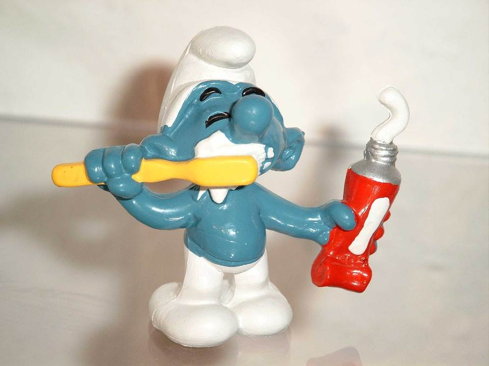 a toy gnome brushing its teeth