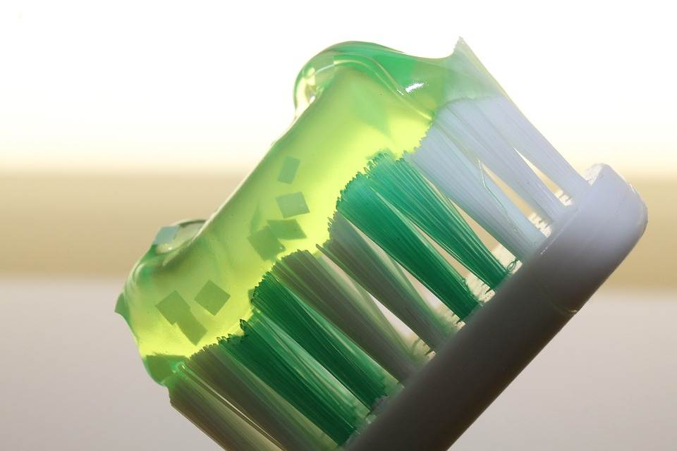 green toothpaste on a green tooth brush