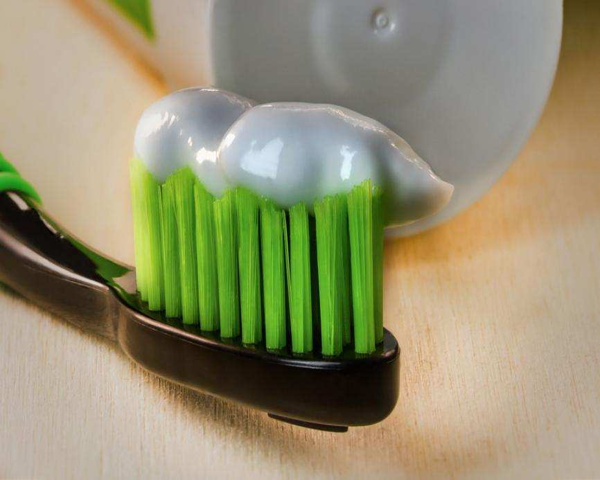 toothpaste on a green toothbrush