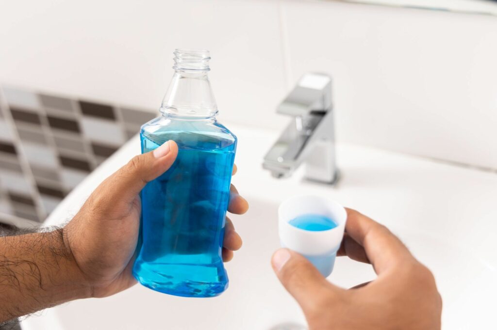 a people using mouthwash