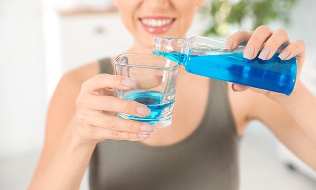 a women using the mouthwash