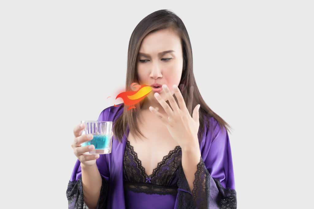 a woman using mouth spray