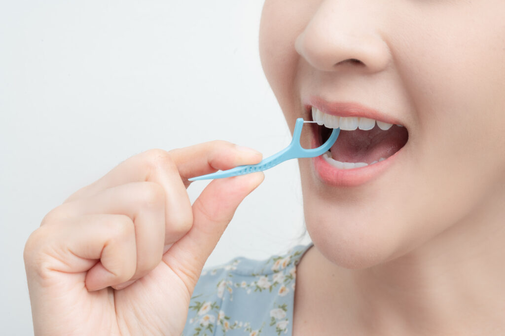 a woman using dental floss