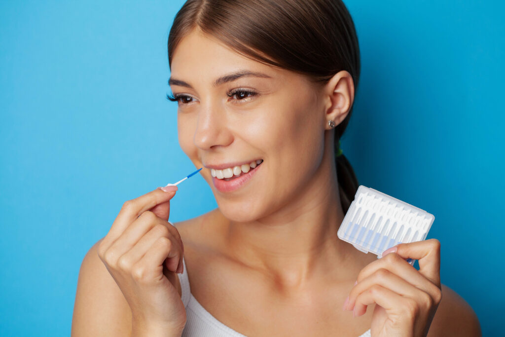 a woman using Interdental Brushes