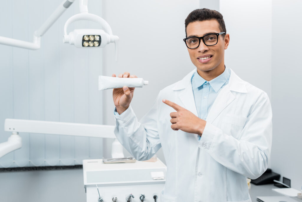 a dentist holding a toothpaste